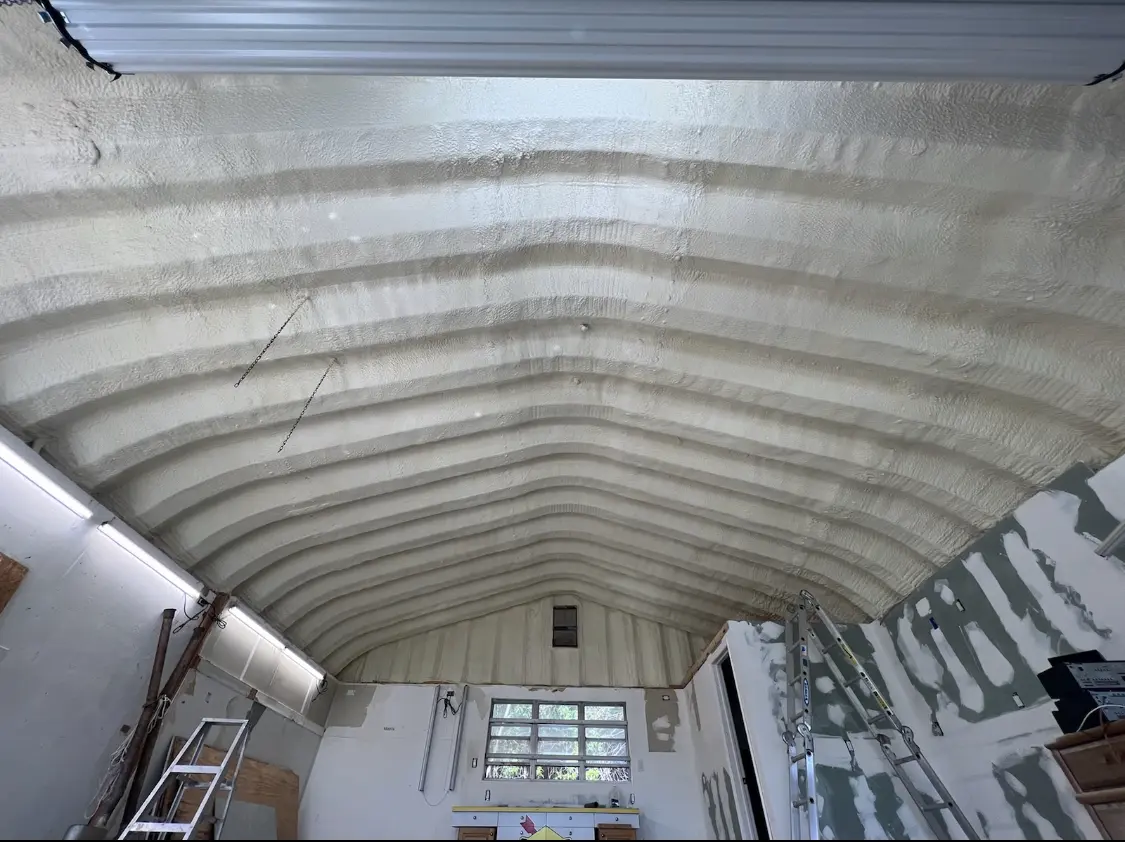 Spray polyurethane foam applied to the underside of a metal roof deck in Lindon
